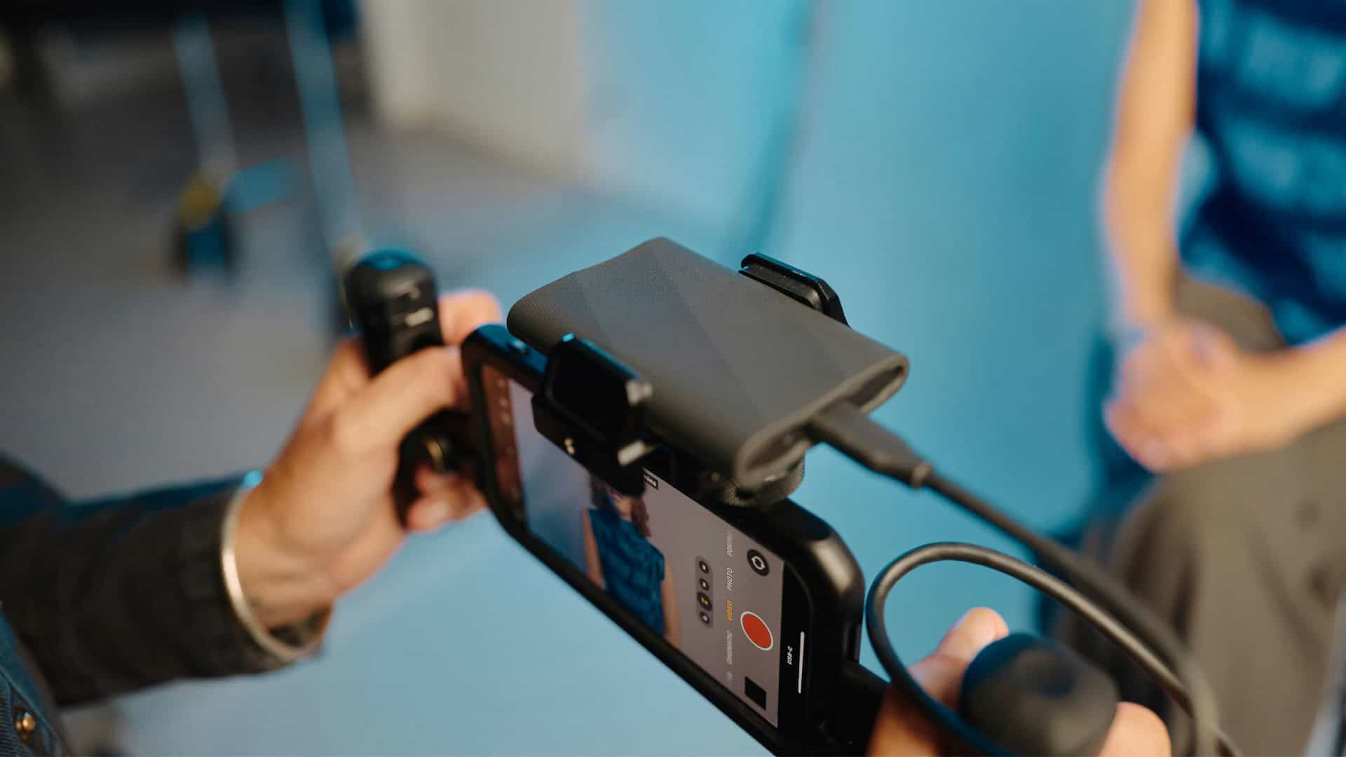Phone_Filming Church consultant providing media, video, and design training with streaming setup in a church environment